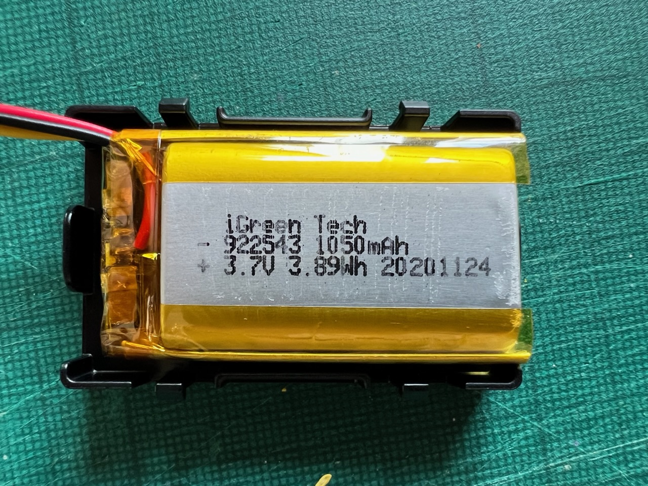 The internal battery of a VanMoof X3 Smart Cartridge with the protective foam removed revealing the battery's specification.