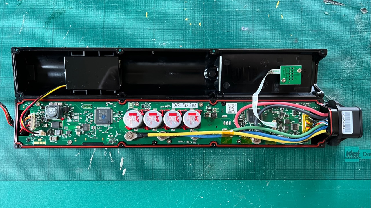 An opened VanMoof X3 Smart Cartridge showing it's circuit board and internal battery.