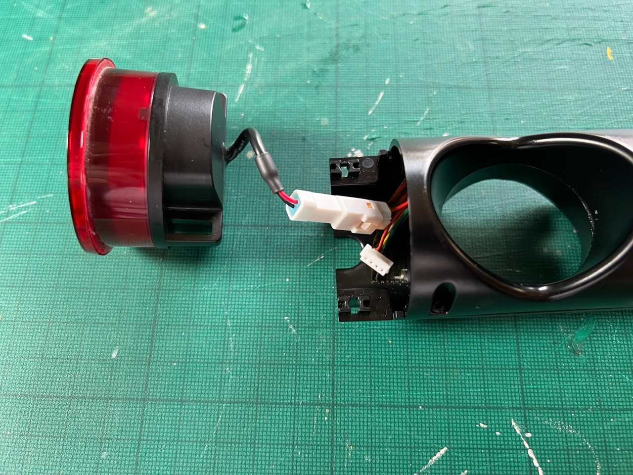 A partially disassembled rear-light assembly from a VanMoof X3's Smart Cartridge.